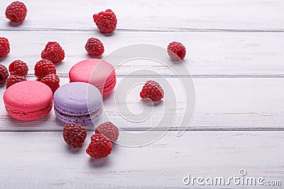 Delicious colorful biscuits macaroons with raspberries over white wooden background. space for text Stock Photo