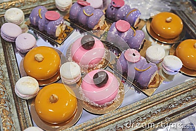 Delicious colorful cookies and cakes on the wedding candy bar. Stock Photo