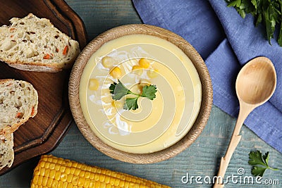 Delicious corn cream soup served on blue wooden table, flat lay Stock Photo