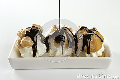 Delicious cream puff cake with chocolate syrup Stock Photo