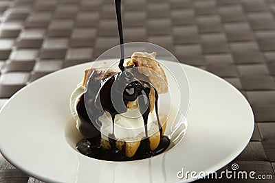 Delicious cream puff cake with chocolate syrup Stock Photo