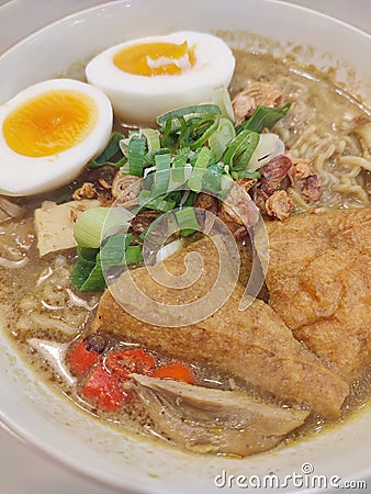 Delicious curry chicken noodle with tofu and boiled egg Stock Photo