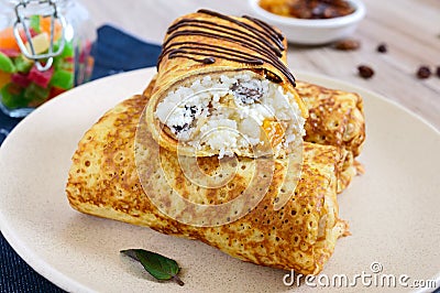 Delicious delicate pancakes with cottage cheese, vanilla and raisins on a plate. Healthy breakfast. Stock Photo