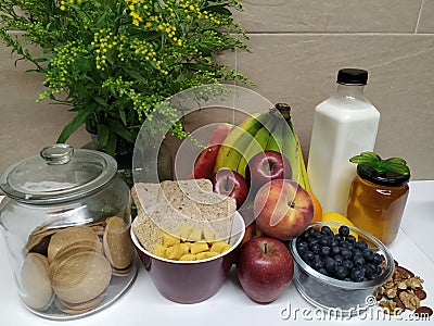 Healthy breakfast with assortment of fruits and flowers Stock Photo