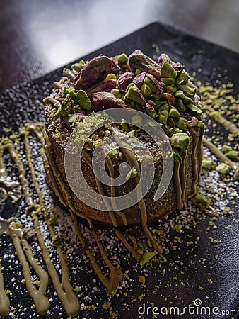 Delicious Dessert pistachio served on a plate. milk puddings and custards vertical Stock Photo