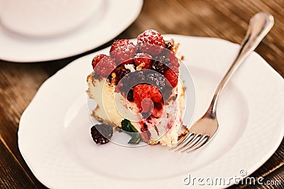 Delicious dessert on wooden background, defocused. Patisserie concept. Piece of cake with blackberries and raspberries Stock Photo