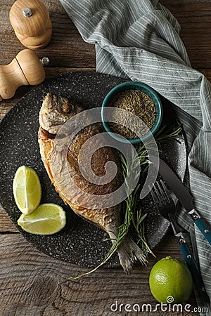 Delicious dorado fish served on wooden table, flat lay Stock Photo