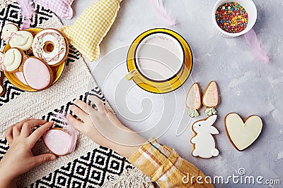 Delicious Easter traditions. Easter spirit with child, delightful cocoa and cookies. Easter joy captured Stock Photo