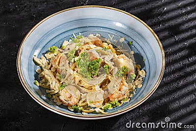 Fettuccine with shrimp and parsley - dark rustic background Stock Photo