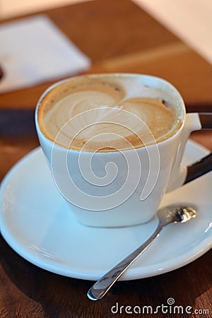 Delicious foamy cappuccino on the wooden table Stock Photo