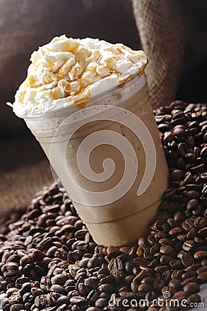 Delicious frappuccino with whipped cream and caramel in the plastic cup Stock Photo