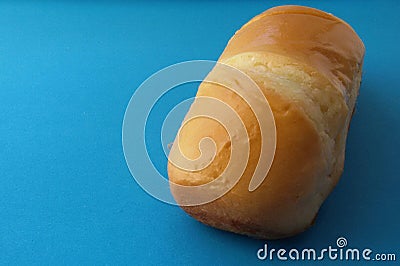 Delicious French roll bread. Soft and sweet bun over blue background. Stock Photo