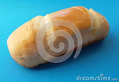 Delicious French roll bread. Soft and sweet bun over blue background. Stock Photo