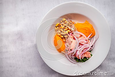 Delicious and fresh ceviche served with onions, sweet potato, toasted corn and lettuce. Stock Photo