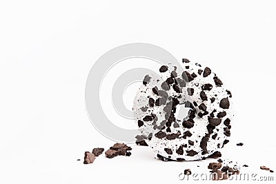 Delicious fresh donut black and white color with white icing and chocolate chips closeup on a white background Stock Photo