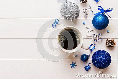 Delicious fresh festive morning coffee in a ceramic cup with little wrapped gifts, ornament and xmas toy. Cup of coffee Stock Photo