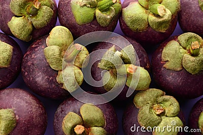 Delicious fresh mangosteens on color background, closeup Stock Photo