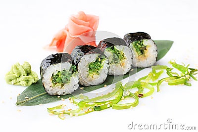 Delicious fresh mini-rolls with algae of Chukka on a banana leaf. Sushi rolls on a white background with ginger and Stock Photo