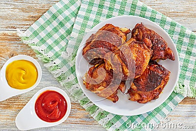 Delicious fried chicken thigh on white plate on table cloth Stock Photo