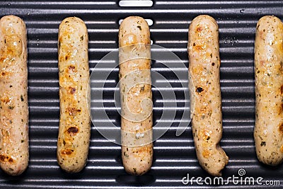 Delicious german sausages on the barbecue electro grill. Tasty sausages sizzling on a portable electric grilling on a summer Stock Photo