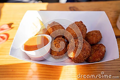 delicious golden brown crab cake platter with red dipping sauce Stock Photo