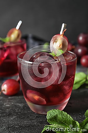 Delicious grape soda water on black table. Refreshing drink Stock Photo