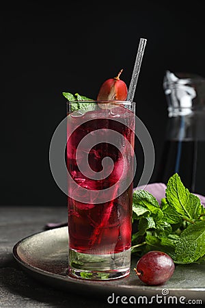 Delicious grape soda water with mint on grey table. Refreshing drink Stock Photo