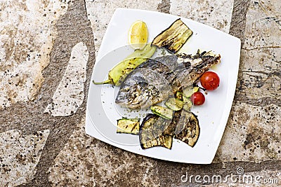 Delicious Grilled bream or dorade fish on wooden background Stock Photo