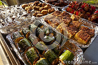 Delicious grilled food on aluminum trays. Stock Photo