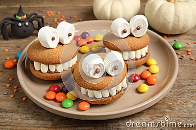 Delicious Halloween themed desserts on wooden table Stock Photo
