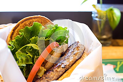 Delicious hamburgher classic with burgher, tomato, lettuce, and roasted onion Stock Photo