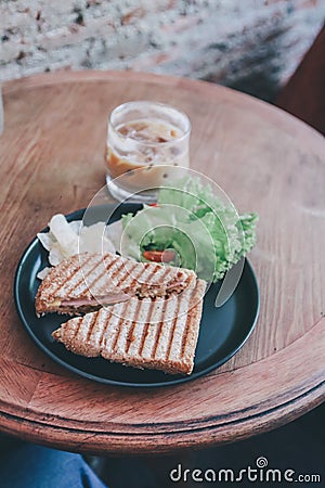 Delicious Healthy Grill sandwich ham cheese and salad lettuce, ham, cheese, tomato and potato chipwith a cup of coffee. Stock Photo