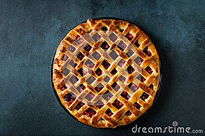 Delicious Homemade Cherry Pie with a Flaky Crust on dark background. Top view. American pie. Cherry dessert. Flatlay Stock Photo
