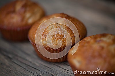 Delicious homemade muffins over wooden board Stock Photo