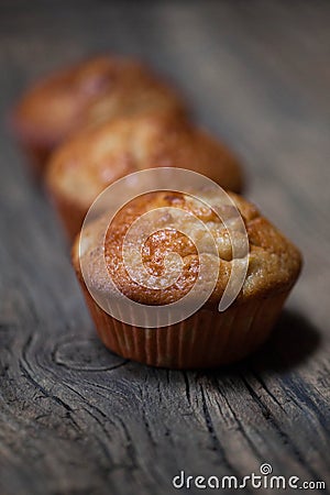 Delicious homemade muffins over wooden board Stock Photo