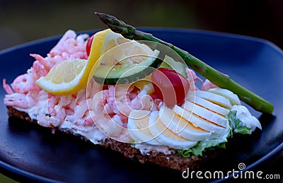 A delicious homemade spicy shrimp sandwich with eggs, citrea, tomatoes, asparagus and sallad Stock Photo