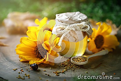 Delicious honey and fresh pollen of flowers on a wooden table. Selective focus. Stock Photo