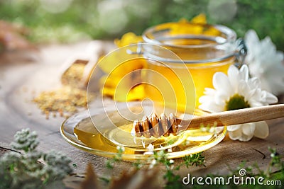 Delicious honey and fresh pollen of flowers on a wooden table. Selective focus. Stock Photo