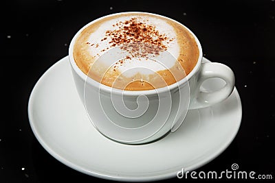 Delicious hot Cappuccino with cinnamon in a white cup. Stock Photo