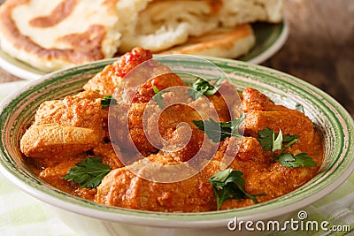 Delicious hot Indian Karhai chicken in a spicy sauce close-up served with fresh naan bread. horizontal Stock Photo