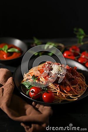 Delicious Italian pasta, Tomato Spaghetti with blurred dark dining table Stock Photo