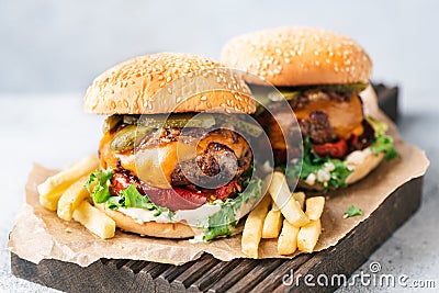 Delicious Juicy Cheeseburgers Served With French Fries Stock Photo