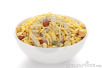 Delicious Khatta Meetha in a white ceramic bowl made with peanuts sugar raisins and besan sev Stock Photo