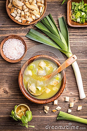 Delicious leek soup in wooden bowl Stock Photo