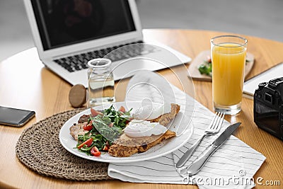 Delicious lunch served on table with laptop Stock Photo