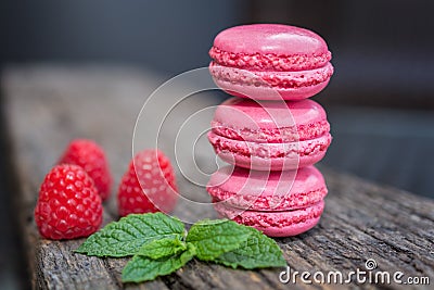 Delicious macarons raspberry flavored with fresh raspberries and Stock Photo