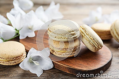 Delicious macarons and white bellflowers on table Stock Photo