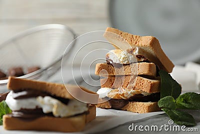 Delicious marshmallow sandwich with bread and chocolate on white wooden table, closeup Stock Photo