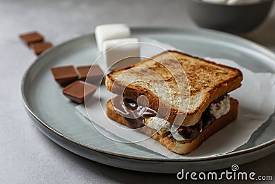 Delicious marshmallow sandwiches with bread and chocolate on wooden table, closeup Stock Photo