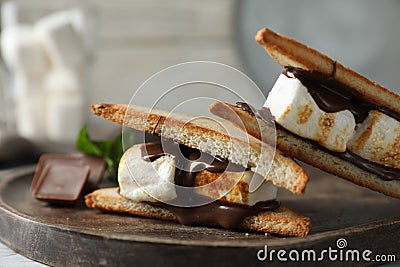 Delicious marshmallow sandwiches with chocolate on wooden tray, closeup Stock Photo